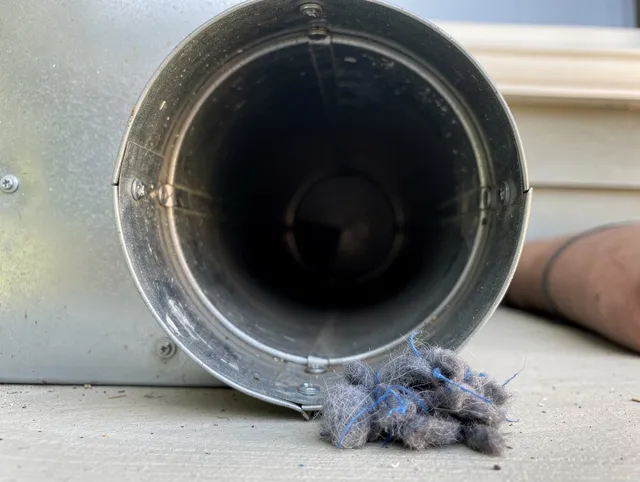 Wayland Dryer Vent Cleaning technician using specialized equipment to clear severe dryer vent blockage in Wayland